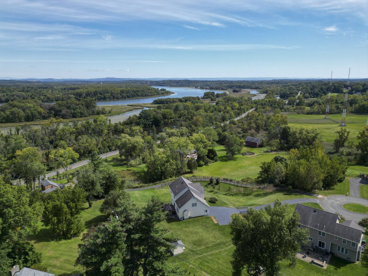 High-altitude drone aerial over country estate and river valley, Capital Region NY