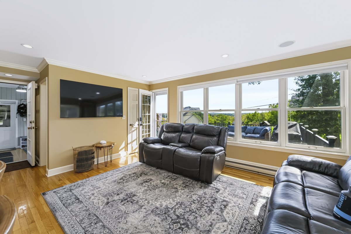 Remodeled gourmet kitchen with white cabinetry, stainless appliances, and subway tile