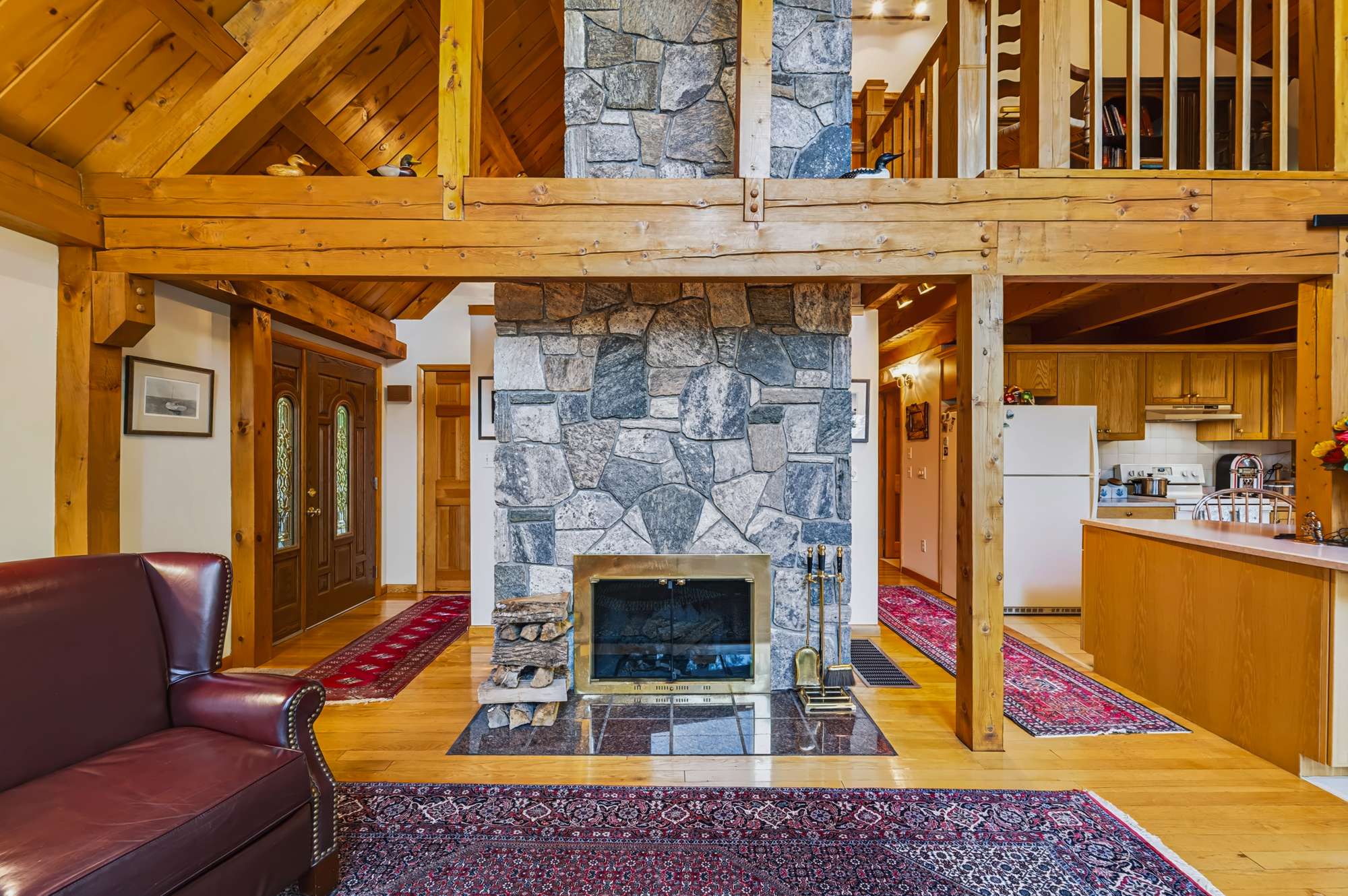 Open kitchen and living area with stone fireplace — Capital Region NY real estate photography