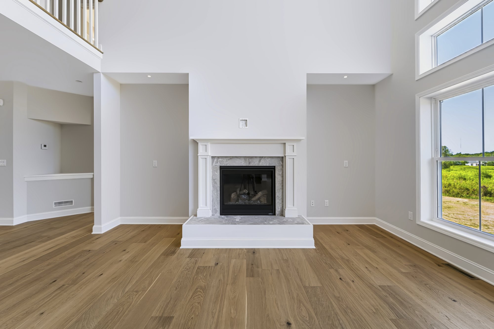 Open-concept great room with staircase, new construction home — Capital Region NY real estate photography