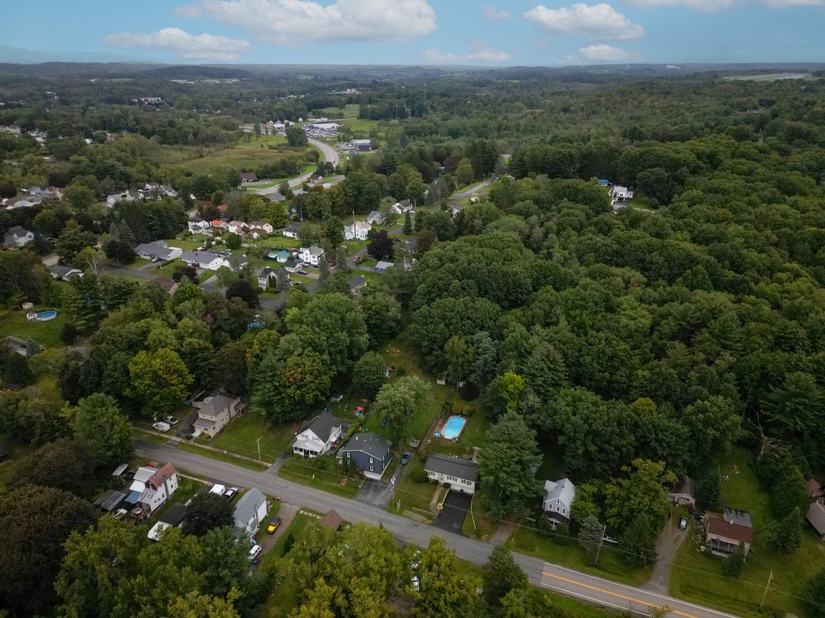 Aerial community overview of neighborhood, rolling hills, and landscape — Capital Region NY