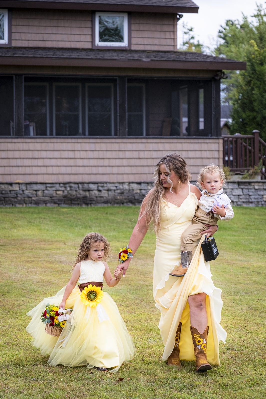 Bridal party walking across the lawn at lakeside wedding venue